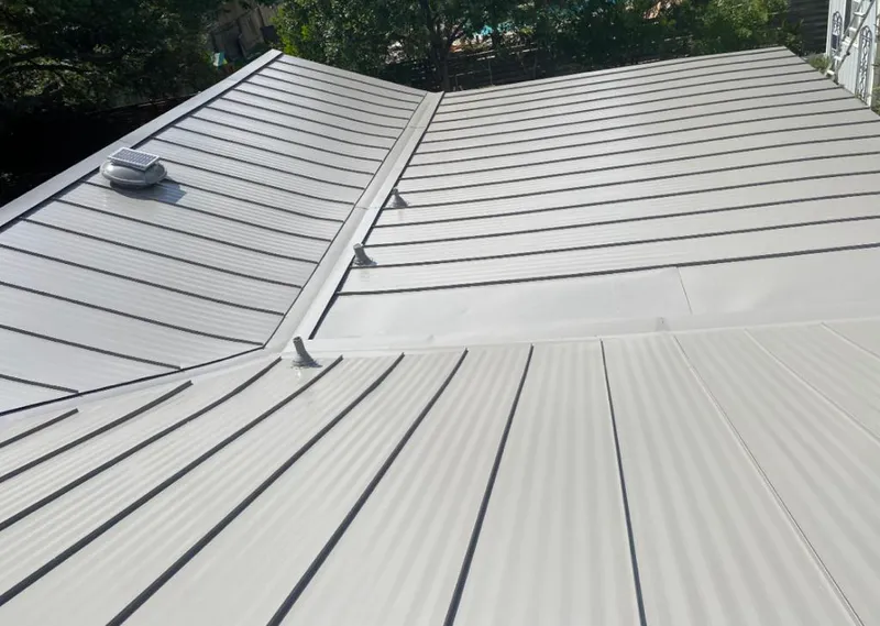 Solar attic fan installed on a metal roof for Roof Ventilation in Cypress